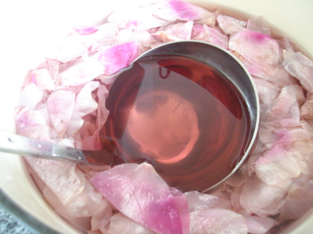 Ladle in homemade rose water
