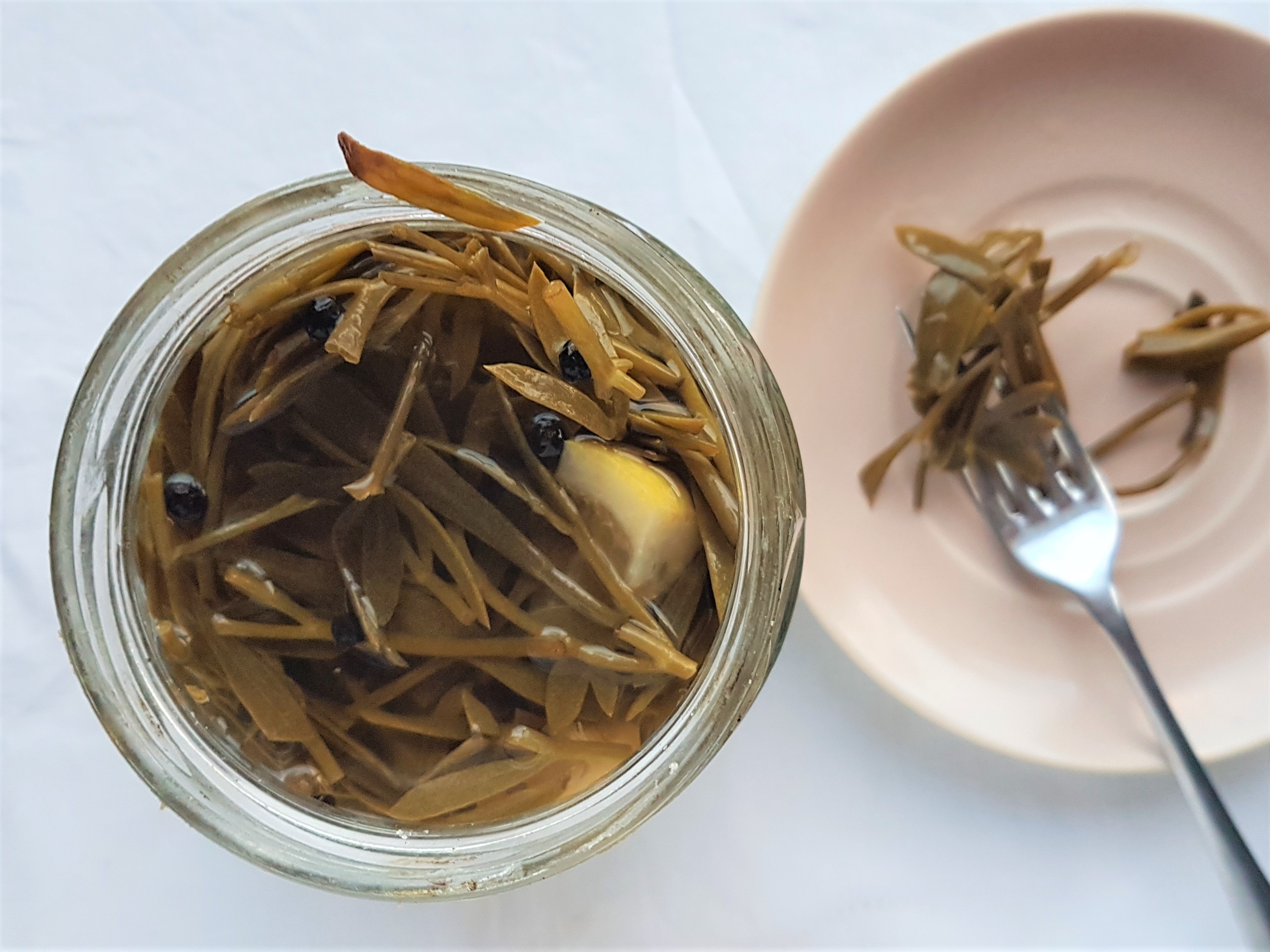 An opened jar of pickled rock samphire