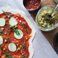 Adding wild toppings before baking the pizza