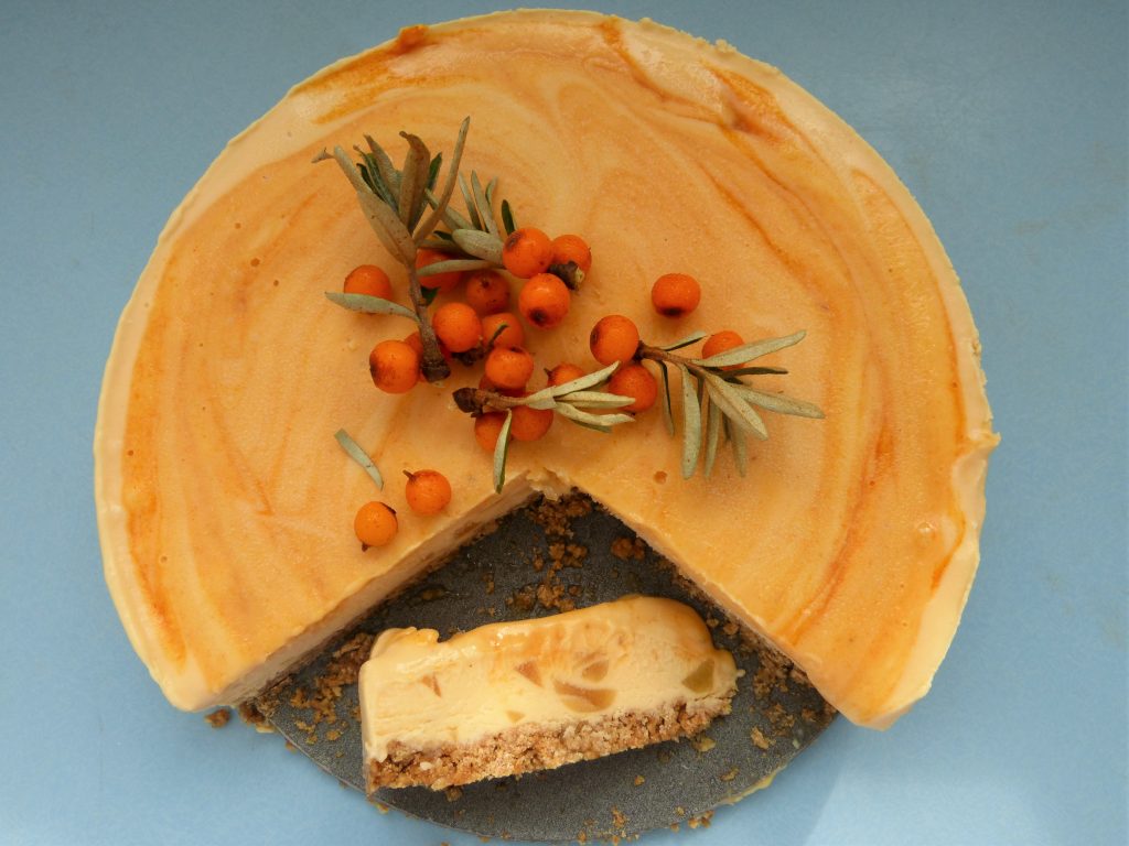 Sea buckthorn cheesecake with a slice on the side