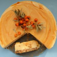 Sea buckthorn cheesecake with a slice on the side