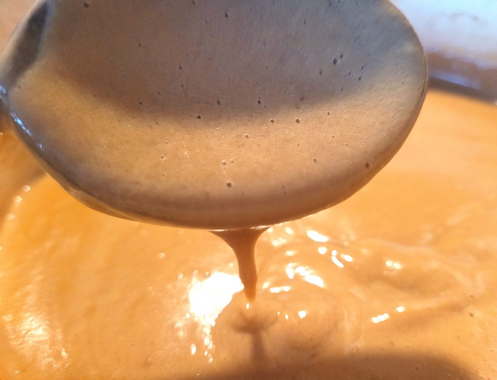 Making a custard as part of the medlar ripple ice cream