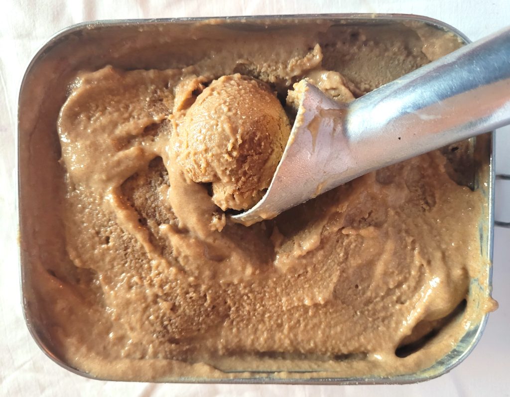 Taking a scoop of homemade medlar ice cream